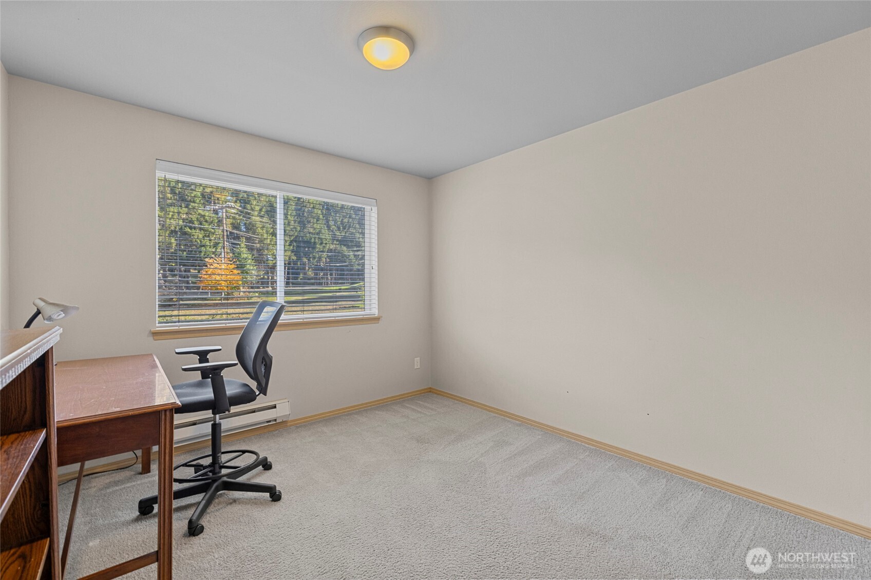 10709 Valley View Road, Unit B403 Bothell, WA 98011 - Photo 19 of 32 a view of a workspace with furniture and a window