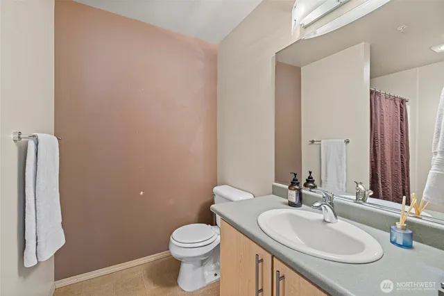 a bathroom with a sink toilet and mirror