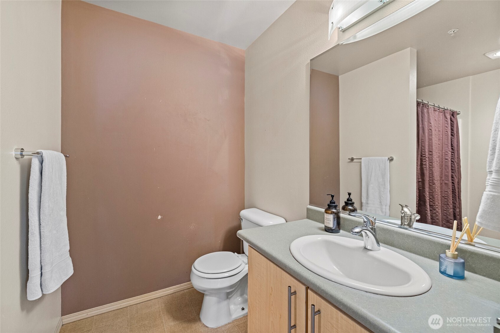 10709 Valley View Road, Unit B403 Bothell, WA 98011 - Photo 20 of 32 a bathroom with a sink toilet and mirror