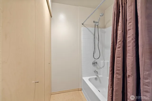 a bathroom with a bathtub and a shower