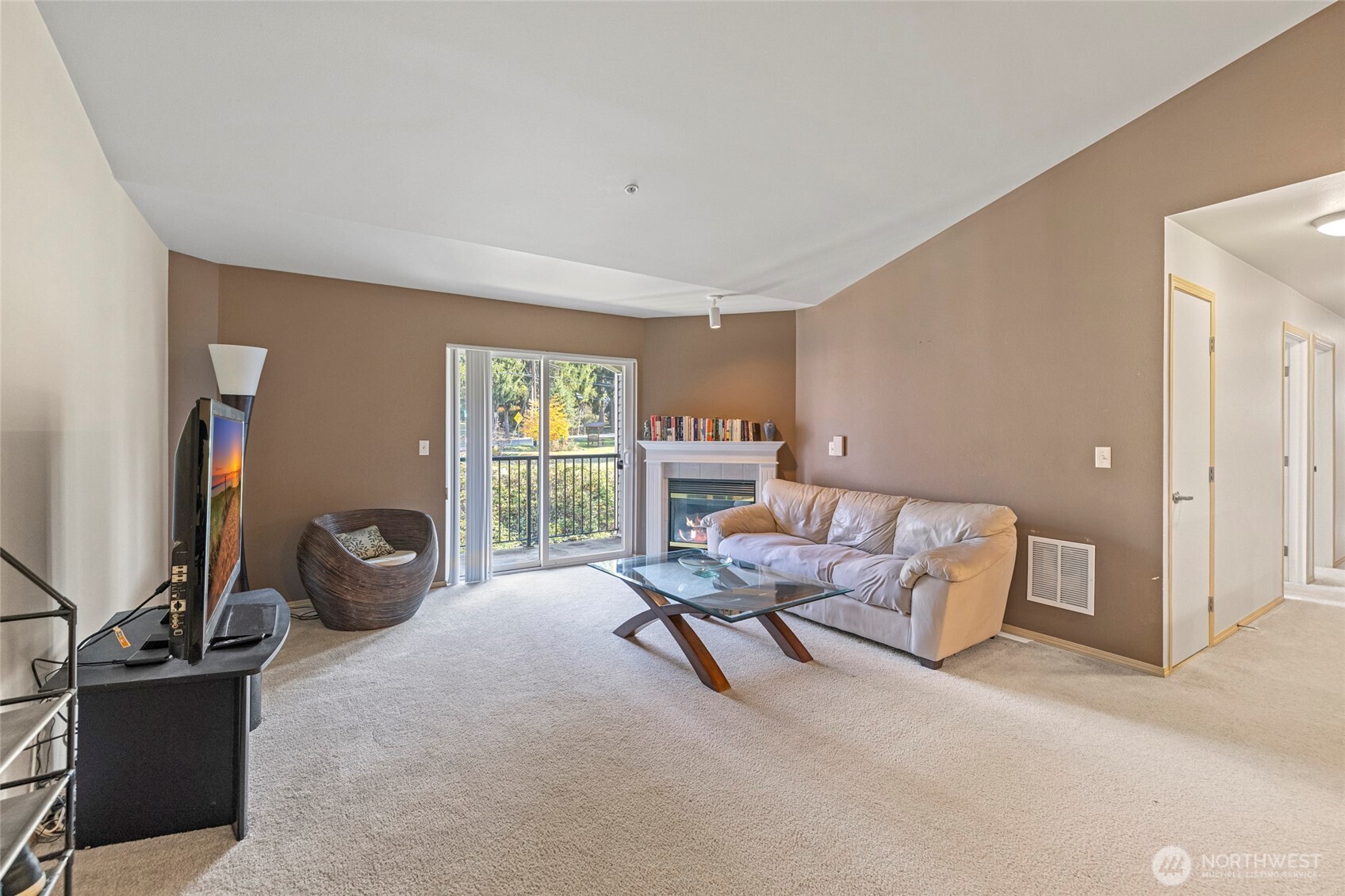 10709 Valley View Road, Unit B403 Bothell, WA 98011 - Photo 6 of 32 a living room with furniture and a flat screen tv