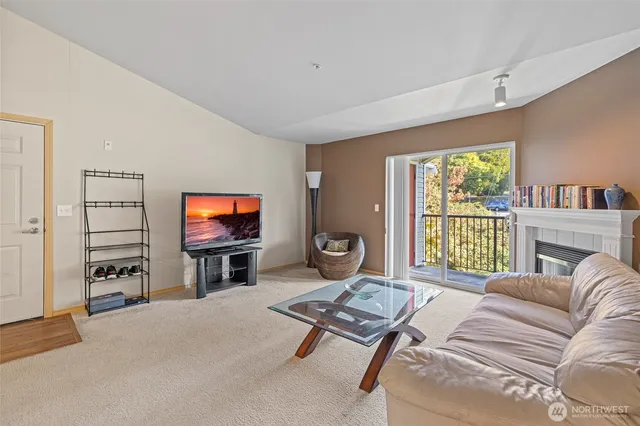 a living room with furniture a flat screen tv and floor to ceiling window