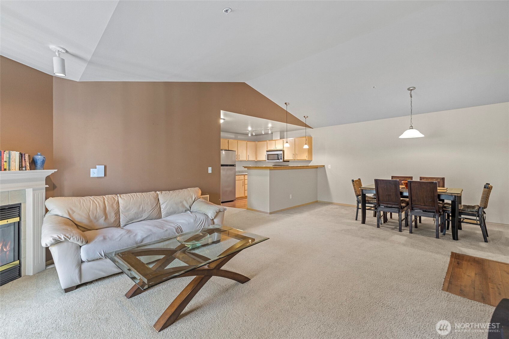 10709 Valley View Road, Unit B403 Bothell, WA 98011 - Photo 10 of 32 a living room with furniture and a dining table with kitchen view