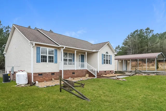a view of a house with a backyard and a patio