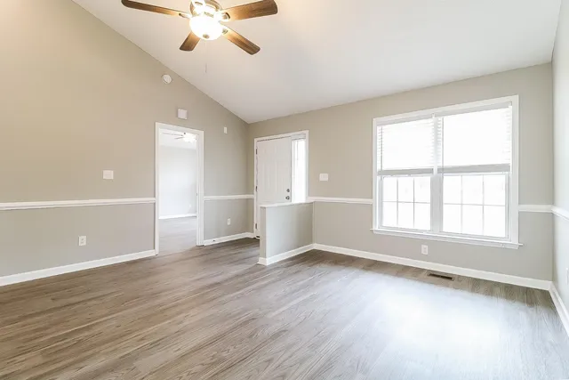 wooden floor in an empty room with a window