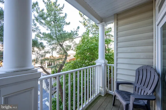 a view of balcony with wooden floor and outdoor seating