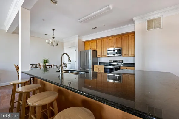 a kitchen with sink refrigerator and stove