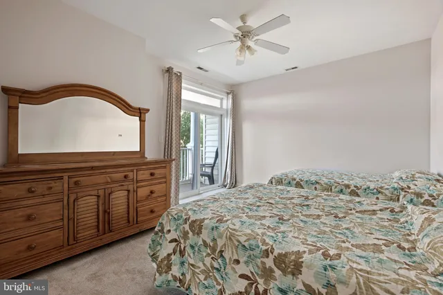 a spacious bedroom with a large bed and a dresser