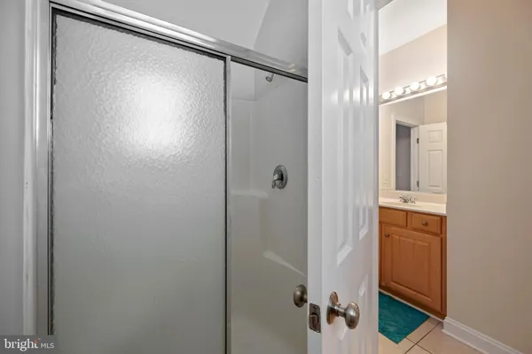 a bathroom with a glass shower door and a mirror