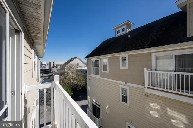 a view of a house with wooden fence