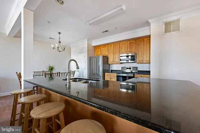 a kitchen with sink refrigerator and stove