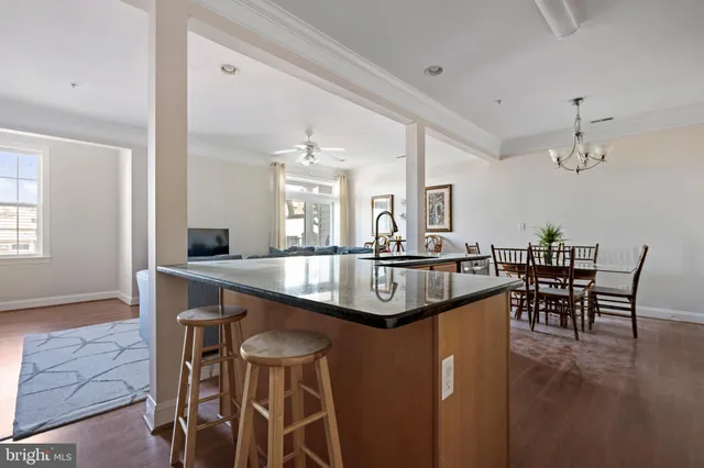 a kitchen with kitchen island granite countertop a sink and counter space