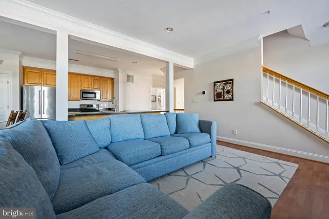a living room with furniture fireplace and a large window