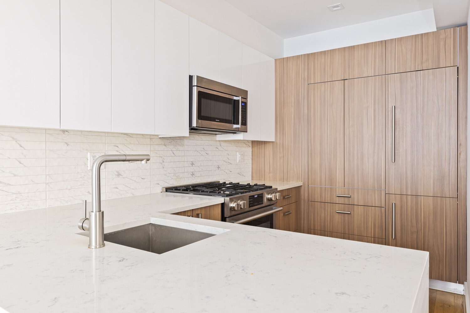 838 Quincy Street, Unit 2F Brooklyn, NY 11221 - Photo 3 of 8 a kitchen with granite countertop a sink stove and microwave