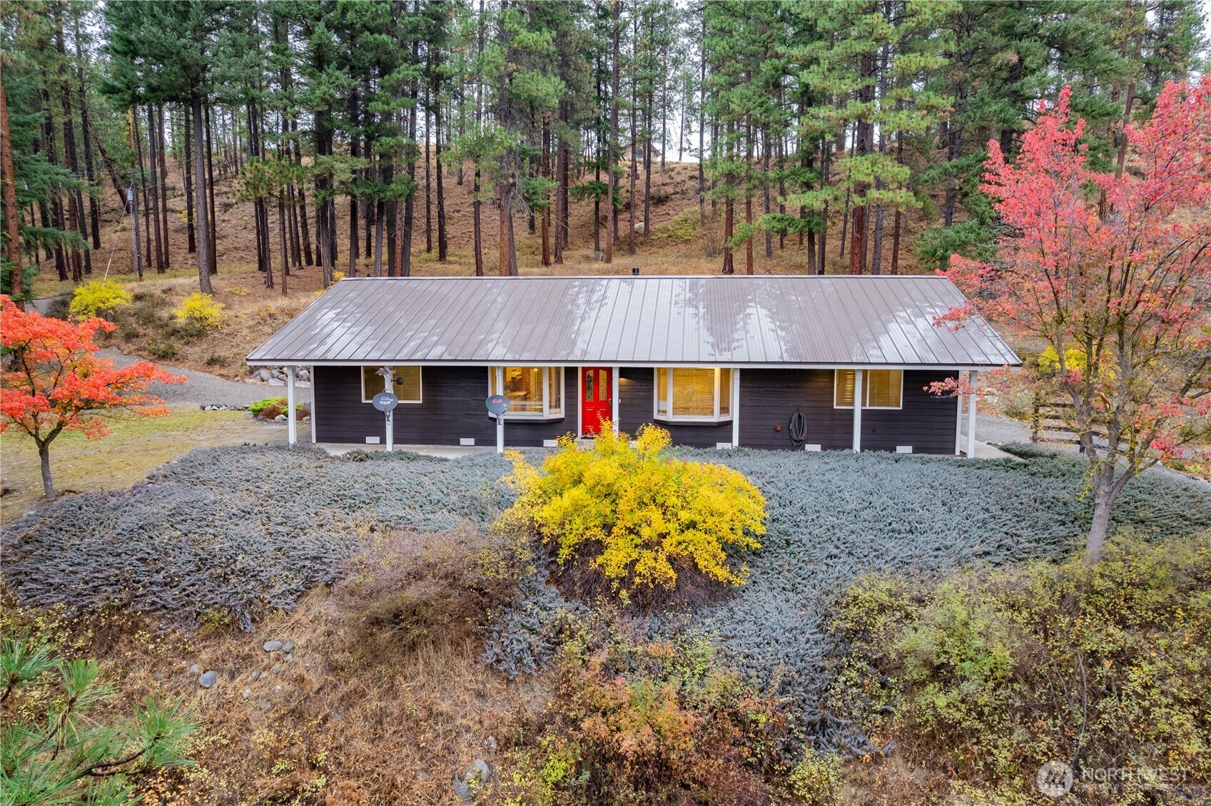 5161 Red Bridge Road Cle Elum, WA 98922 - Photo 2 of 40 a view of a white house with large trees and a yard