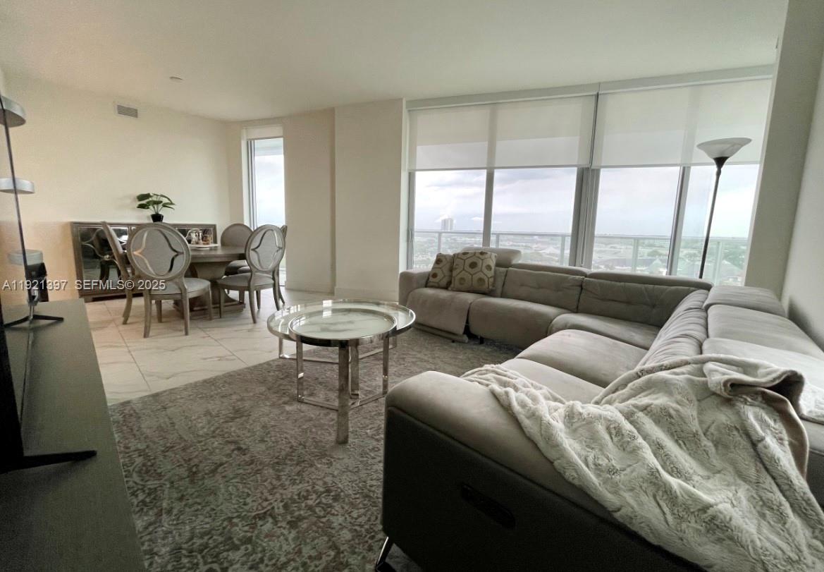 2000 Metropica Way, Unit 1009 Sunrise, FL 33323 - Photo 15 of 40 a living room with furniture and a large window