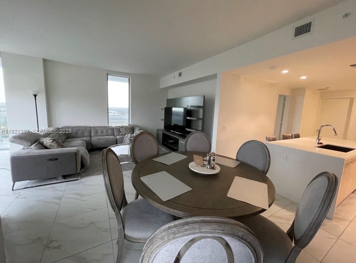 2000 Metropica Way, Unit 1009 Sunrise, FL 33323 - Photo 35 of 40 a living room with furniture kitchen view and a window
