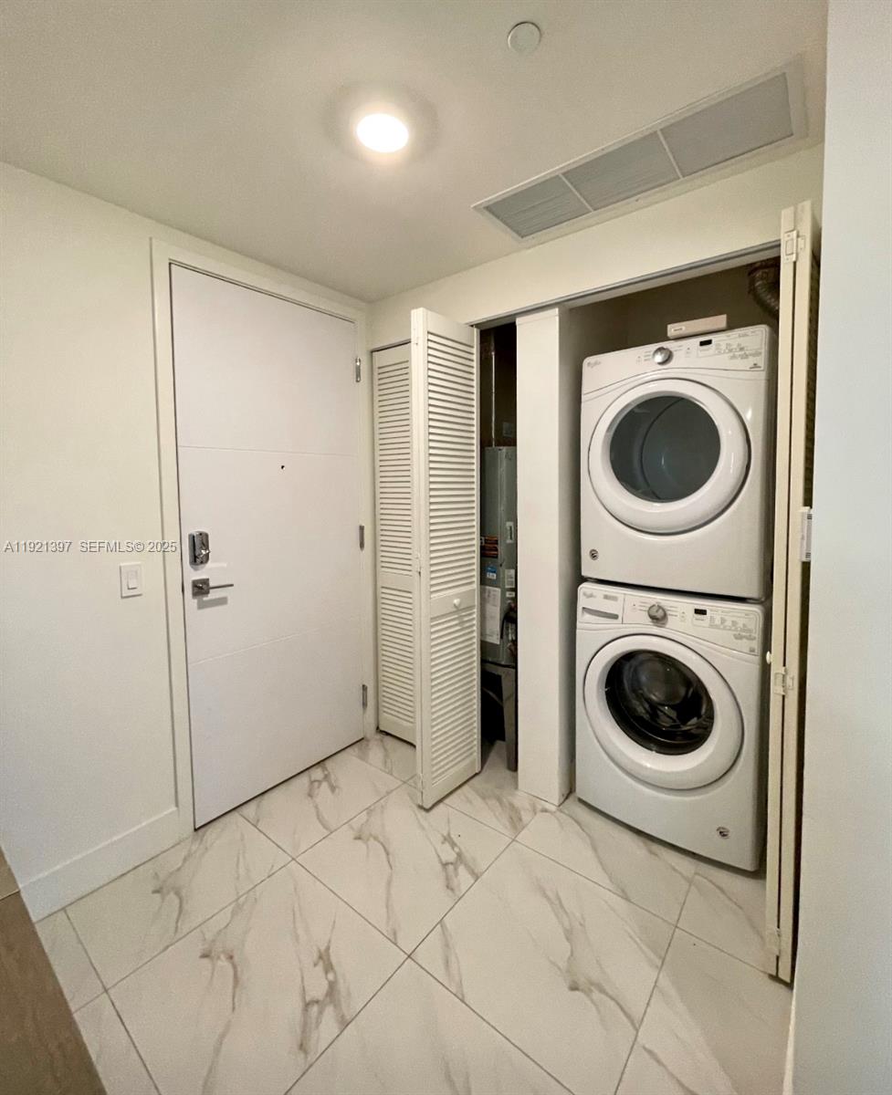 2000 Metropica Way, Unit 1009 Sunrise, FL 33323 - Photo 37 of 40 a view of a hallway with washer and dryer