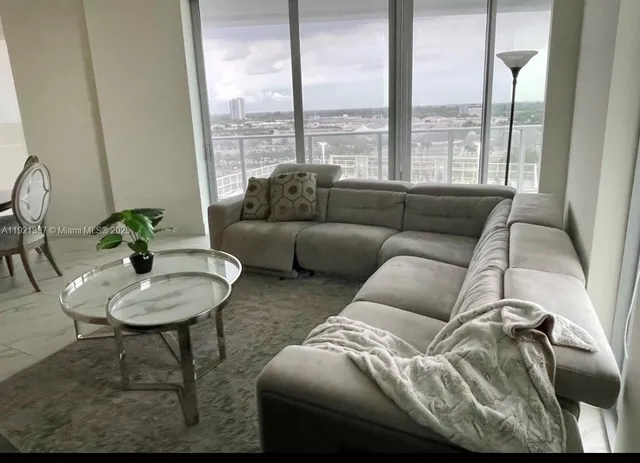 a living room with furniture and a large window