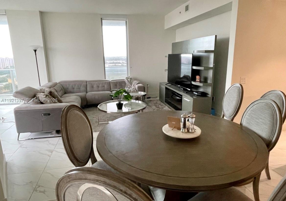 2000 Metropica Way, Unit 1009 Sunrise, FL 33323 - Photo 8 of 40 a living room with furniture and a flat screen tv