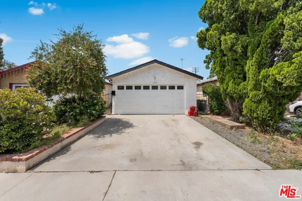 a view of garage with large tree