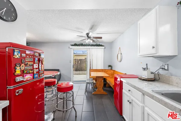 a kitchen with stainless steel appliances granite countertop a sink dishwasher and cabinets with wooden floor