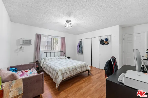 a bedroom with a bed furniture and a window