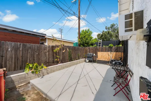 a view of a backyard with furniture and a garage