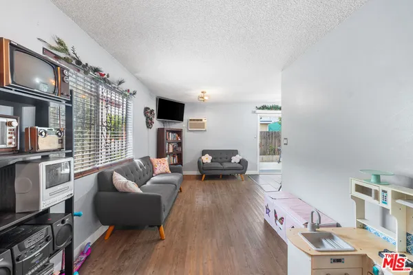 a living room with furniture fireplace and flat screen tv