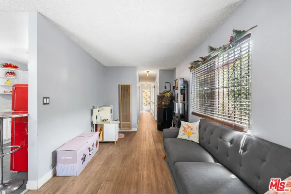 a living room with furniture and large windows