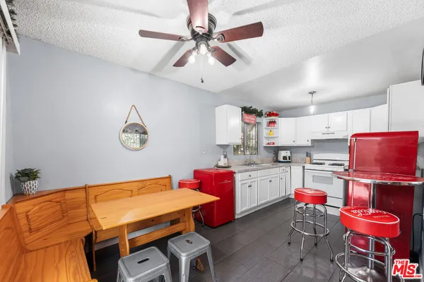 a room with furniture and kitchen view