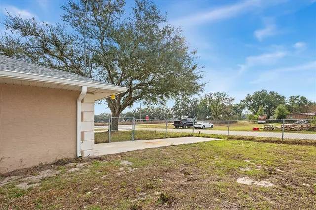 a view of a house with a backyard