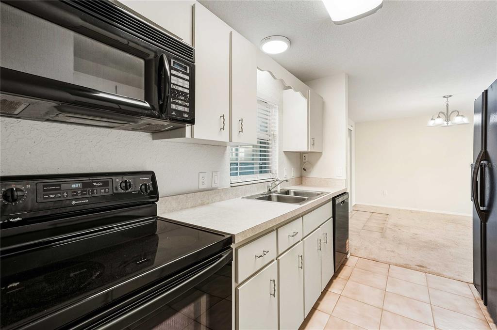 2982 Cr 756a Webster Webster, FL 33597 - Photo 23 of 26 a kitchen with a stove and a microwave