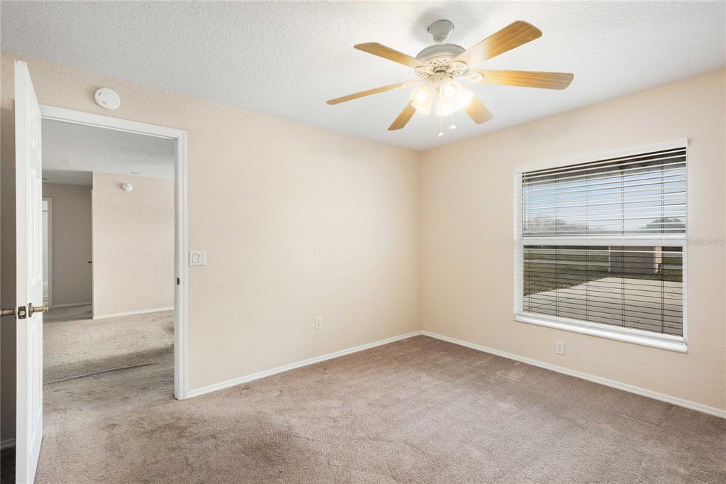 2982 Cr 756a Webster Webster, FL 33597 - Photo 26 of 26 an empty room with windows and fan