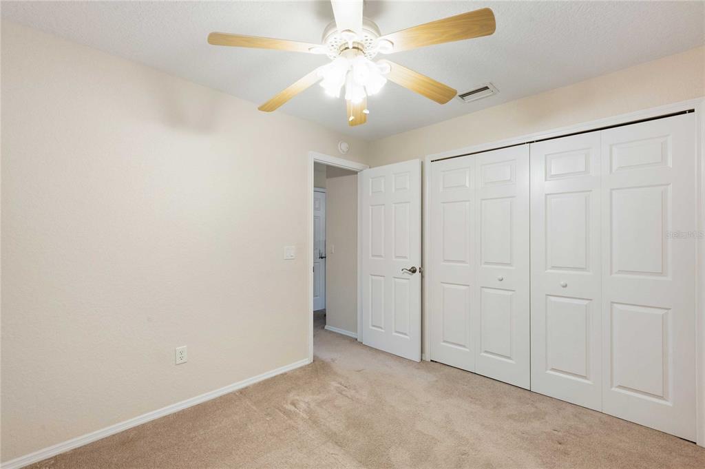 2982 Cr 756a Webster Webster, FL 33597 - Photo 8 of 26 an empty room with a chandelier fan and closet