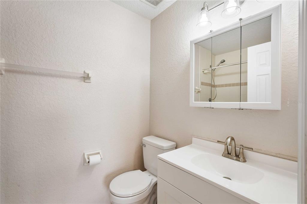 2982 Cr 756a Webster Webster, FL 33597 - Photo 9 of 26 a bathroom with a toilet a sink a mirror and vanity