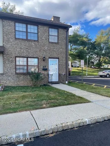 a brick building with a yard