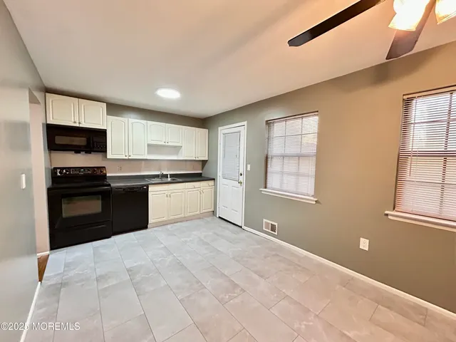 a kitchen with stainless steel appliances granite countertop a stove cabinets and a refrigerator