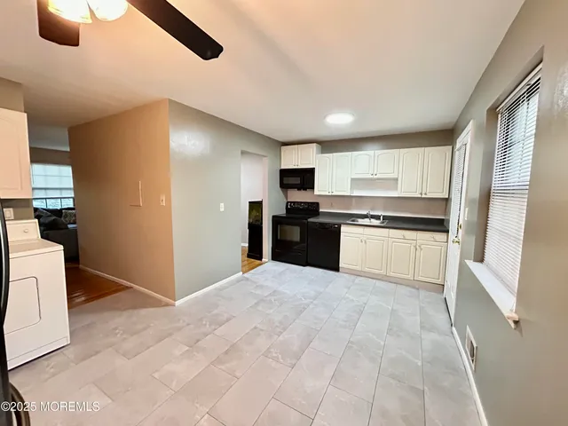 a large kitchen with cabinets and stainless steel appliances