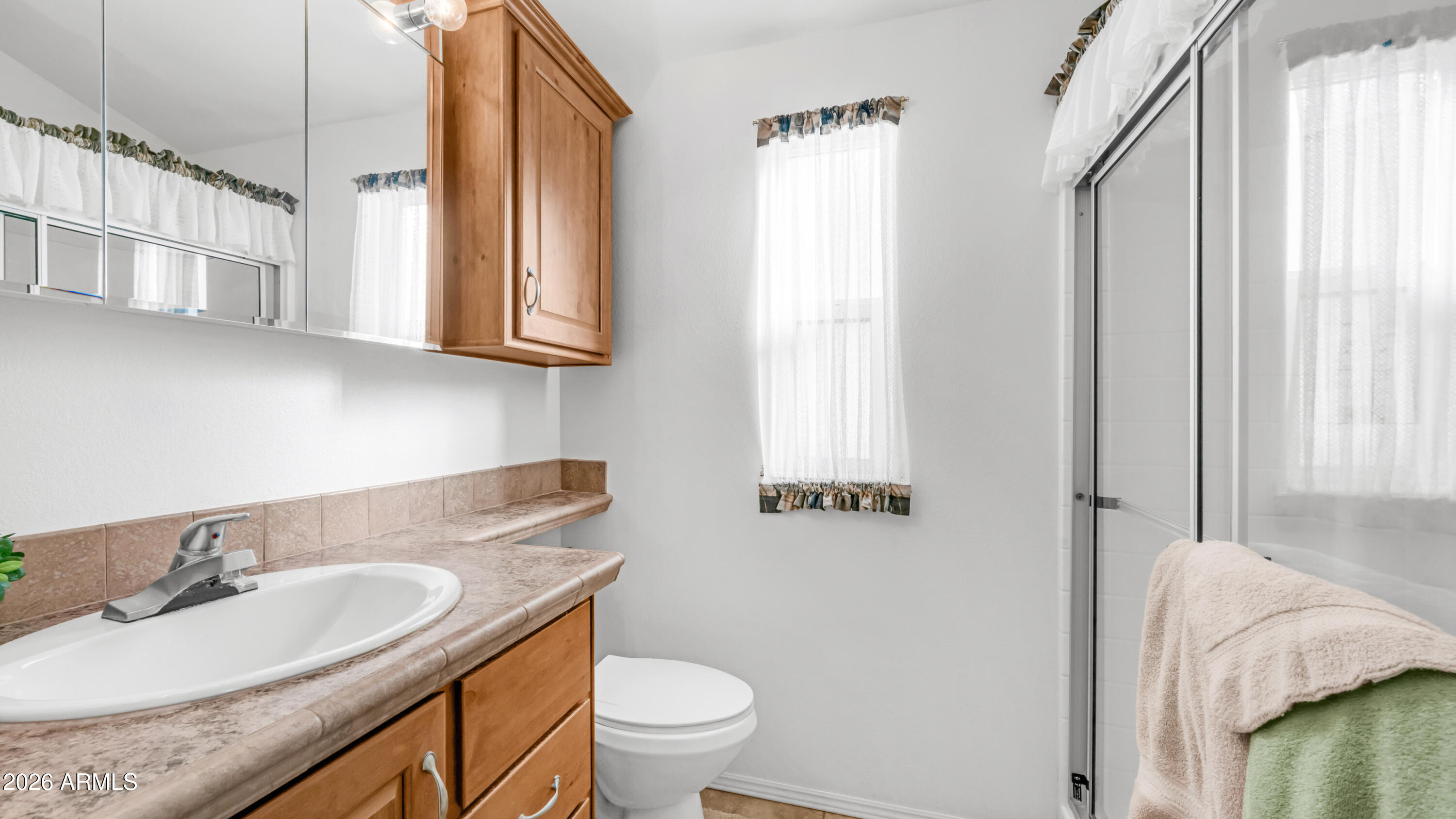 3710 South Goldfield Road, Unit 721 Apache Junction, AZ 85119 - Photo 18 of 63 a bathroom with a granite countertop sink toilet and a mirror