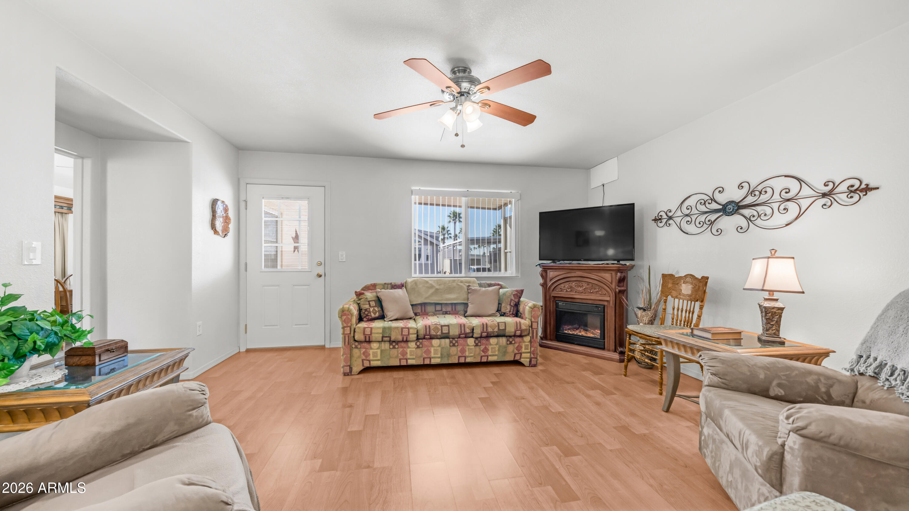 3710 South Goldfield Road, Unit 721 Apache Junction, AZ 85119 - Photo 22 of 63 a living room with furniture a flat screen tv and a fireplace