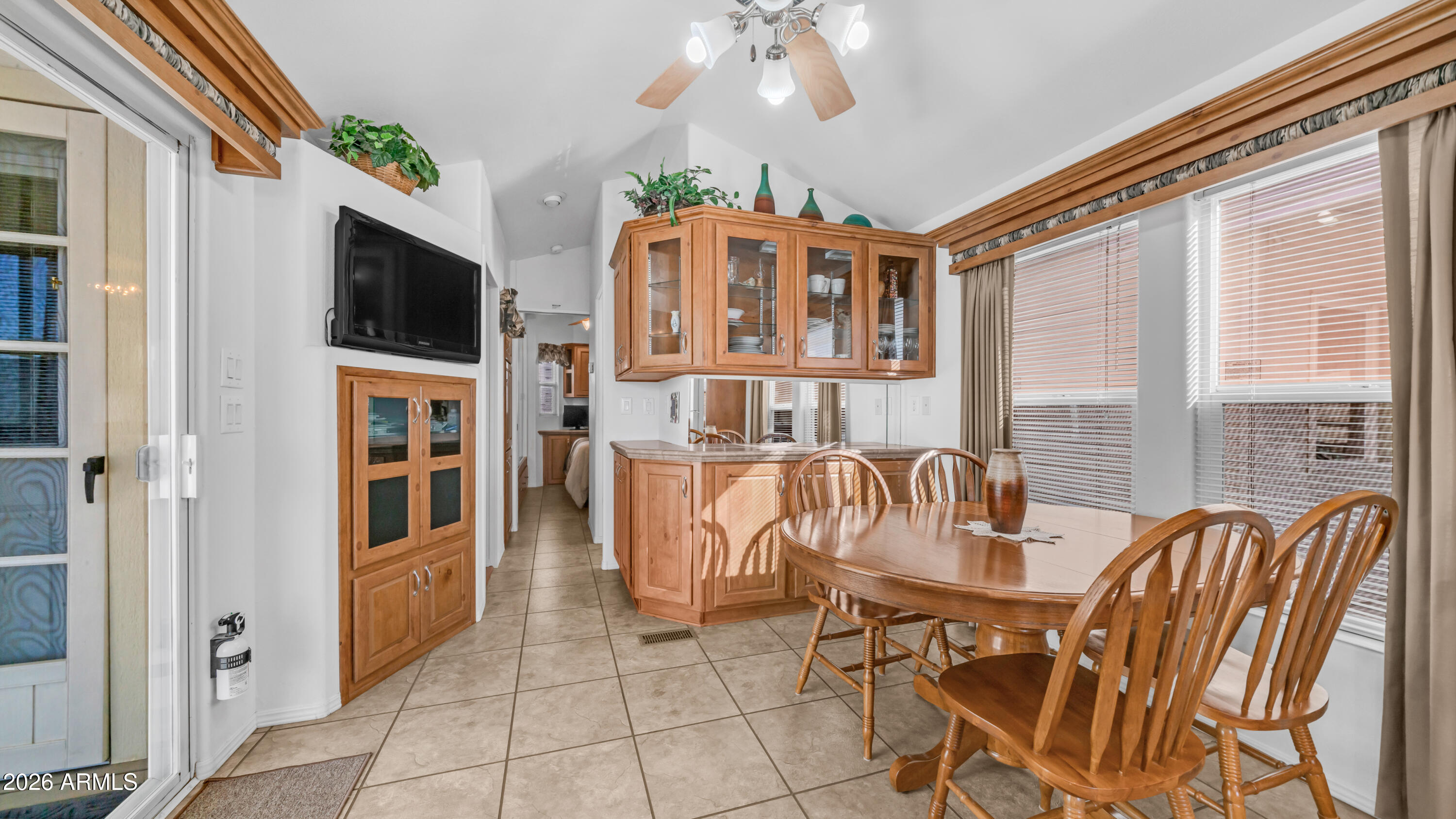 3710 South Goldfield Road, Unit 721 Apache Junction, AZ 85119 - Photo 8 of 63 a dining room with furniture and a flat screen tv