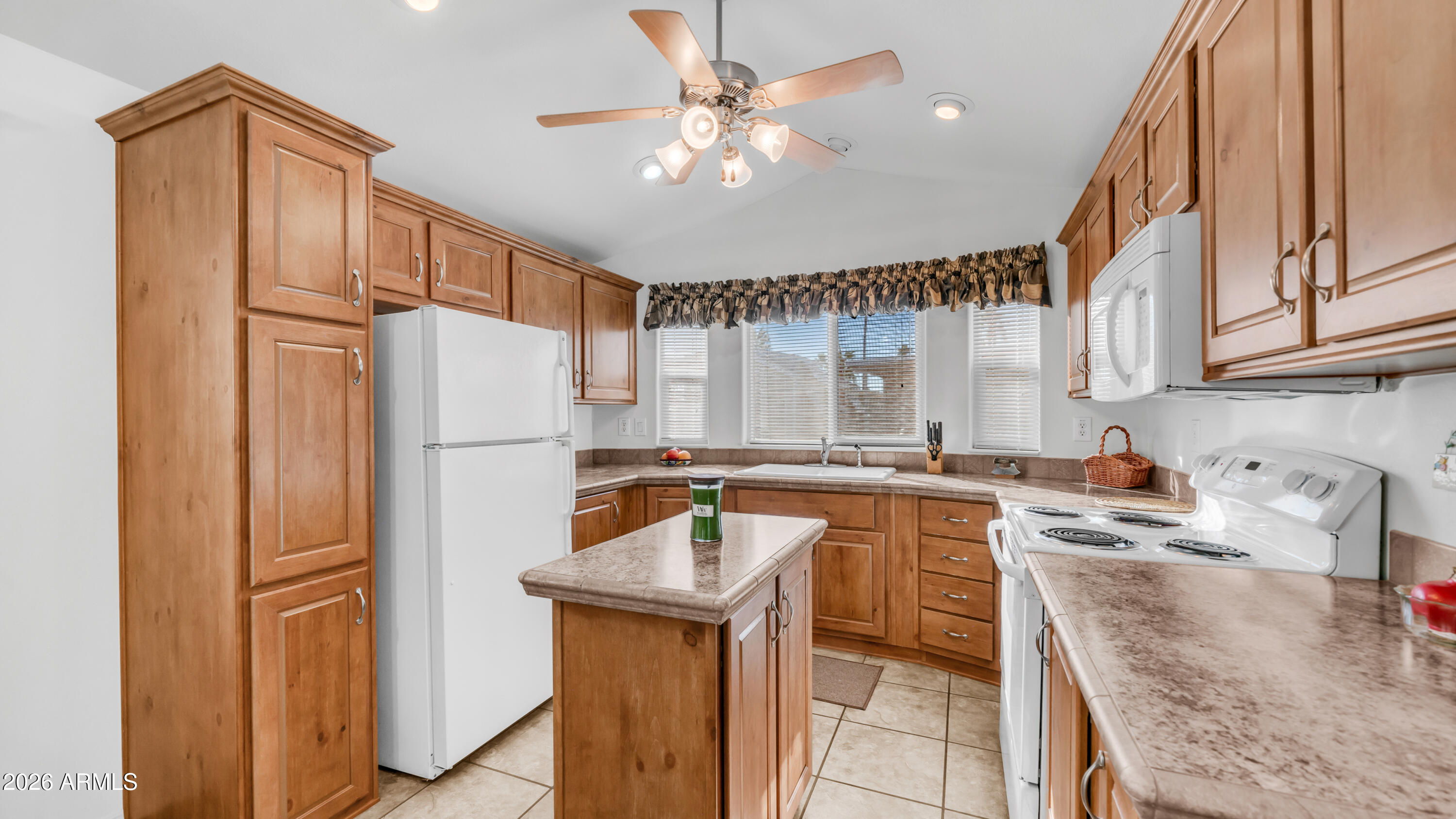 3710 South Goldfield Road, Unit 721 Apache Junction, AZ 85119 - Photo 10 of 63 a kitchen with a refrigerator a sink and cabinets