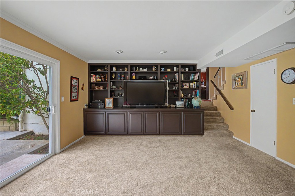22671 Town Crier Road Calabasas, CA 91302 - Photo 14 of 35 a living room with furniture and a flat screen tv