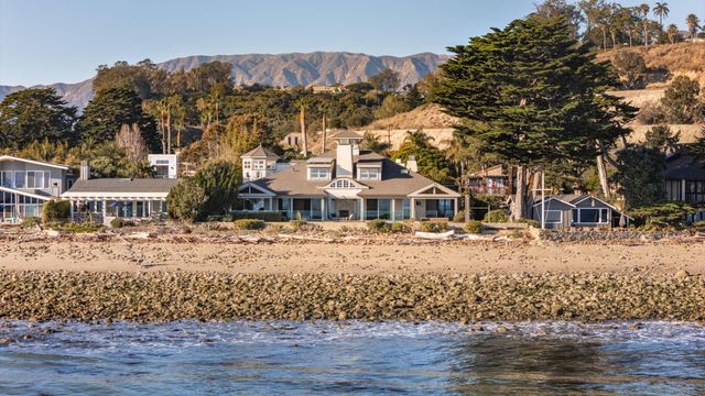 a view of a houses with snow on the road