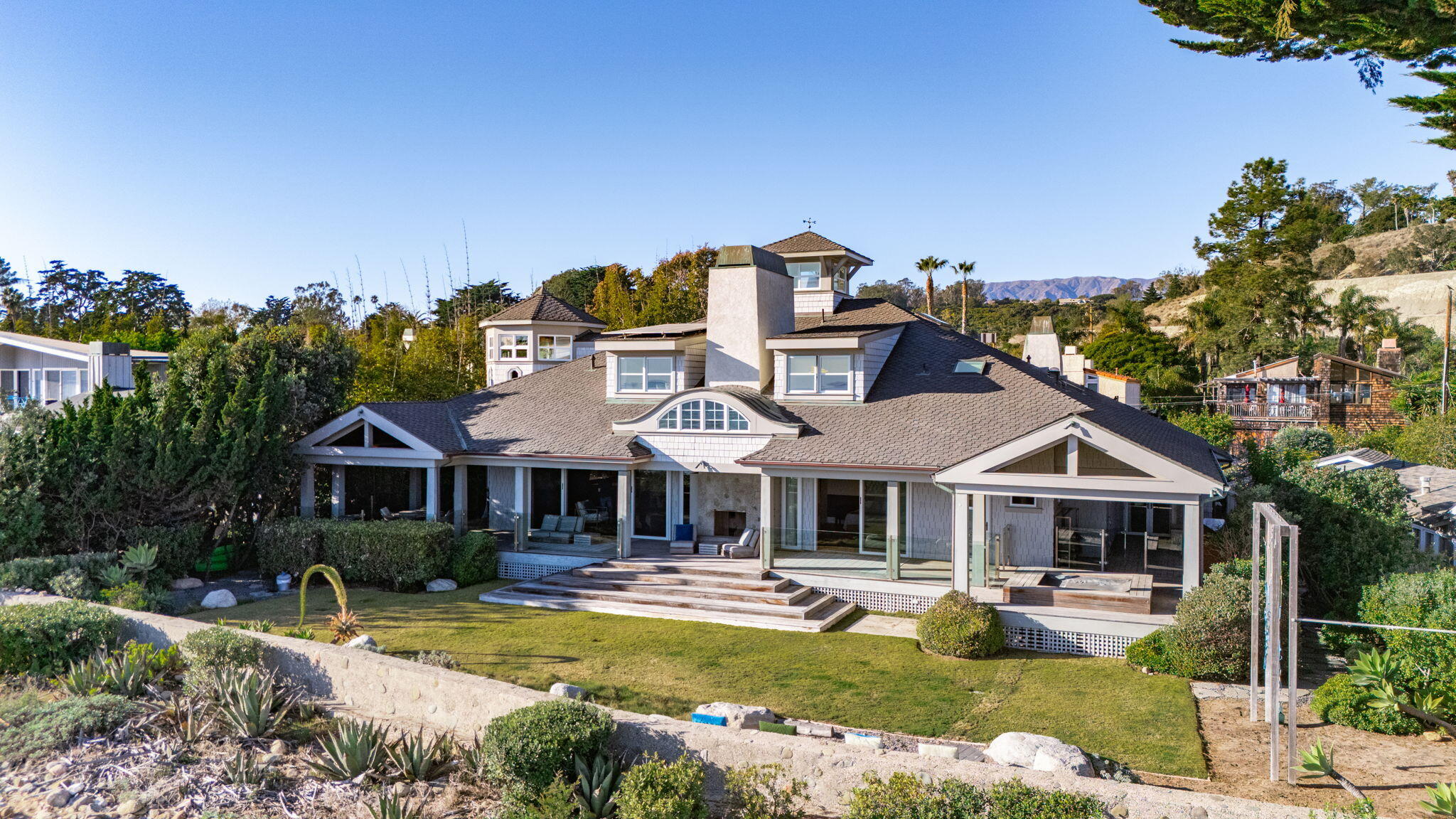 8096 Puesta Del Sol Carpinteria, CA 93013 - Photo 3 of 38 a front view of a house with swimming pool having outdoor seating