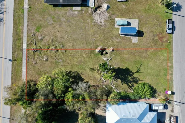 an aerial view of residential houses with yard
