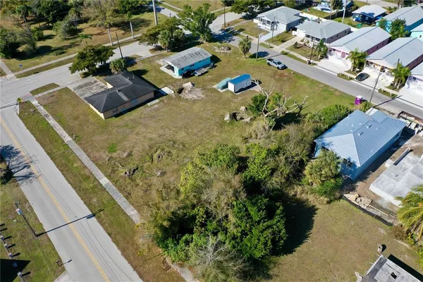 an aerial view of a house with a yard basket ball court and outdoor seating