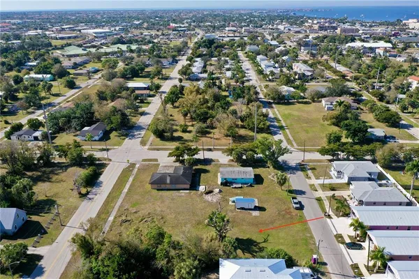 an aerial view of a house with a yard and lake view