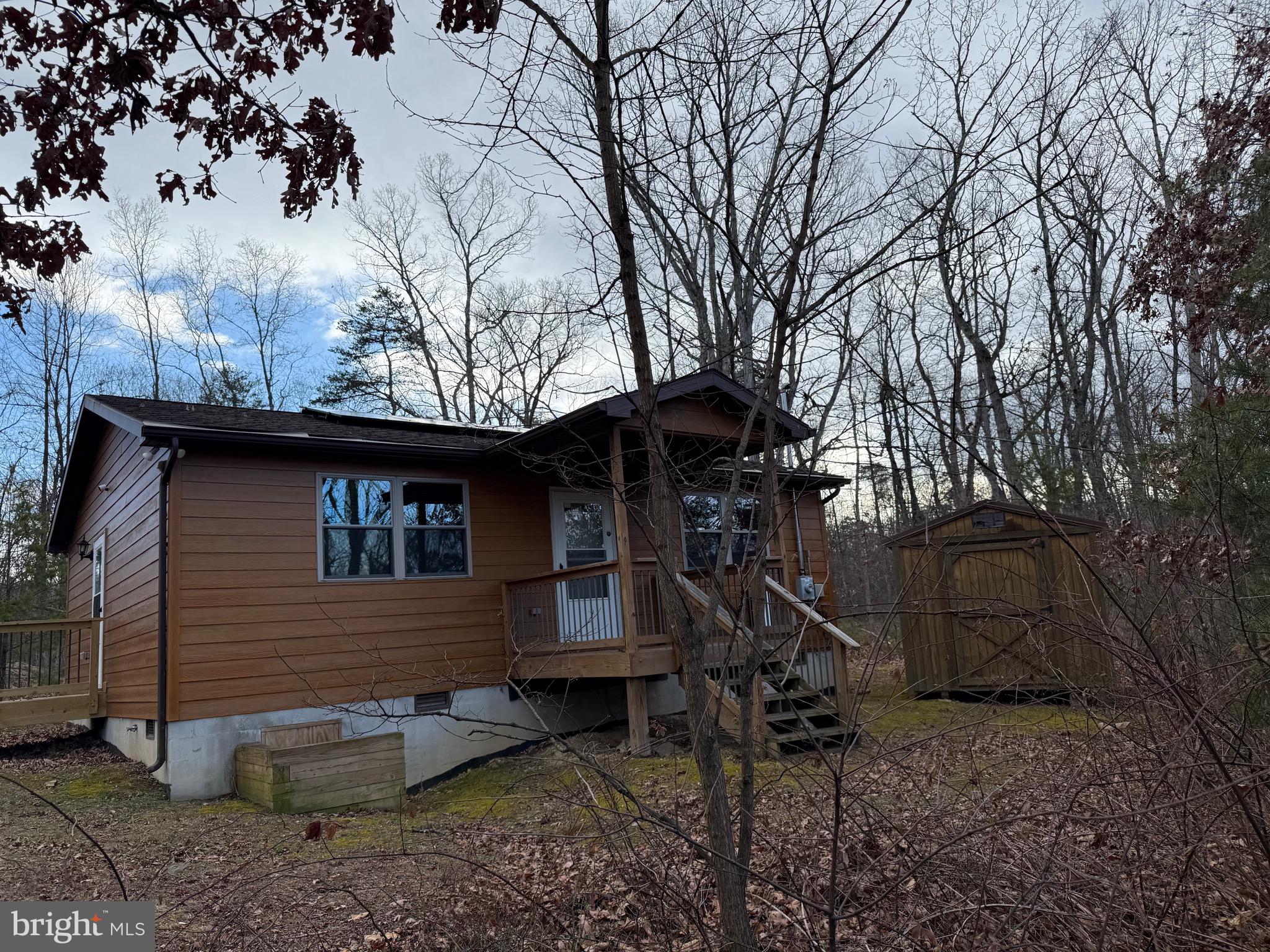 a backyard of a house with barbeque oven table and chairs